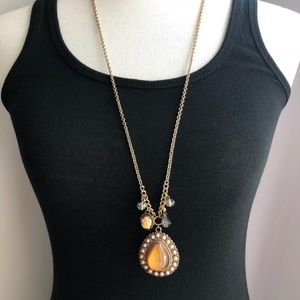 long statement necklace with pendant and charms